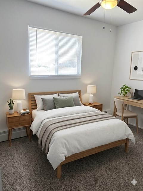 A bedroom with a bed, desk, and chair.
