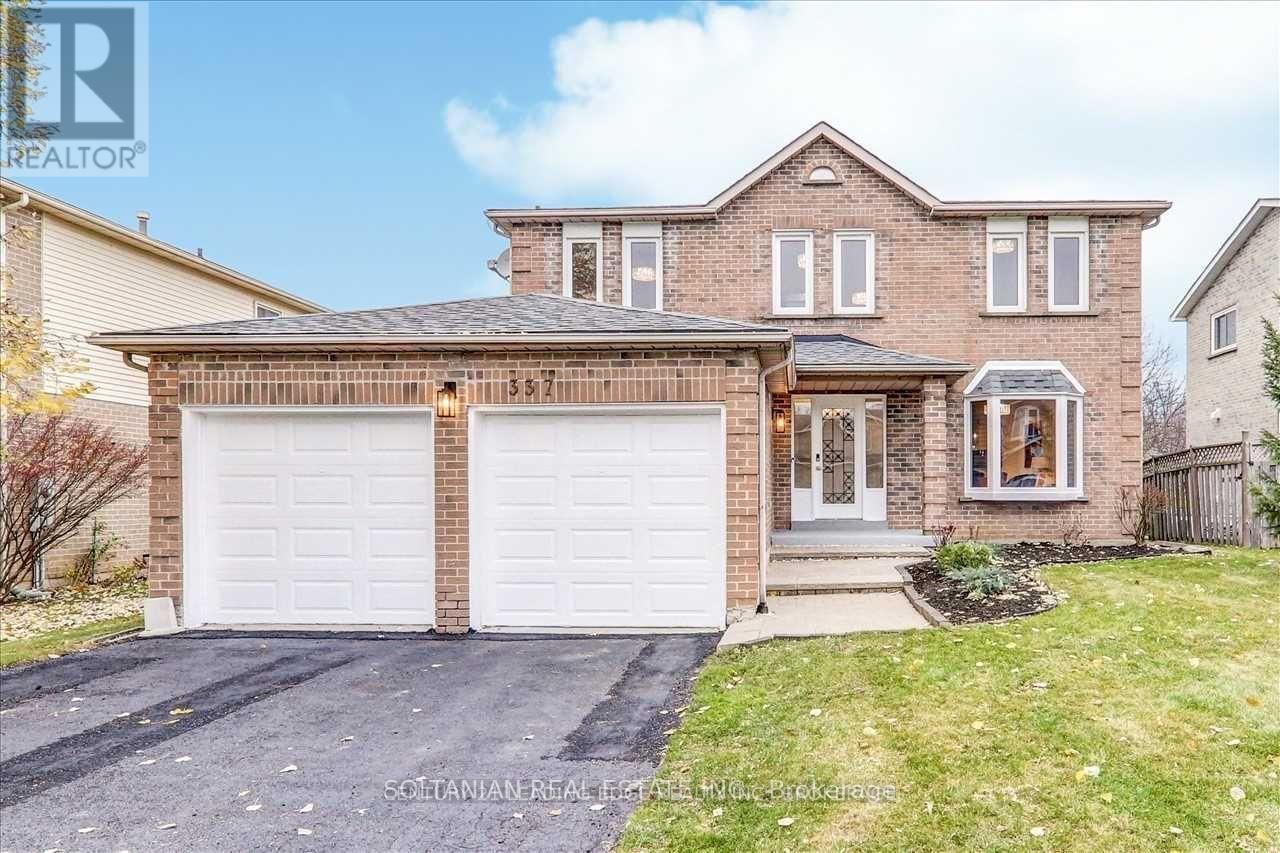 A two-story house with a garage and a driveway.