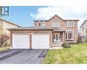 A two-story house with a garage and a driveway.