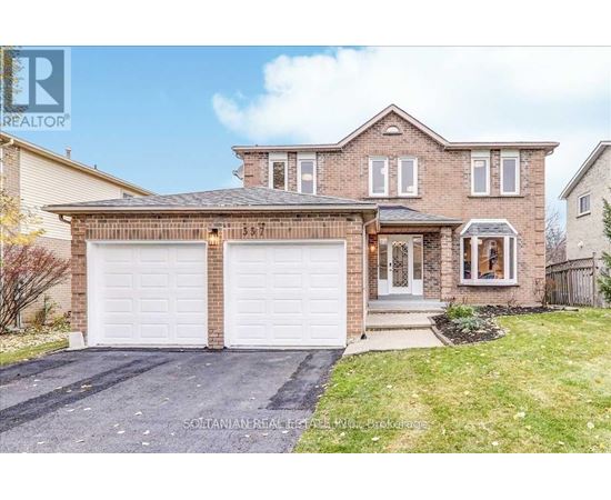 A two-story house with a garage and a driveway.