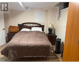 A bedroom with a bed, nightstand, and lamp.