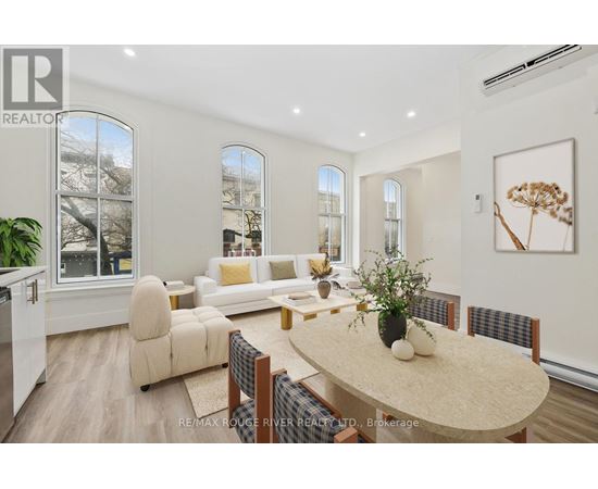 A well-lit, modern dining room with a table set for four.