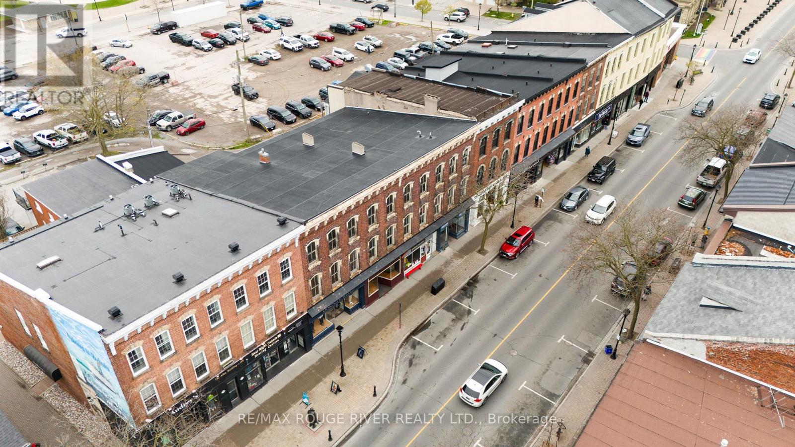 An aerial view of a street with cars and buildings.