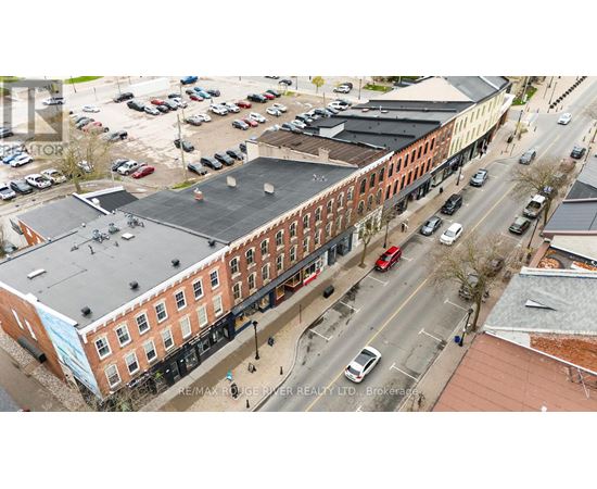 An aerial view of a street with cars and buildings.