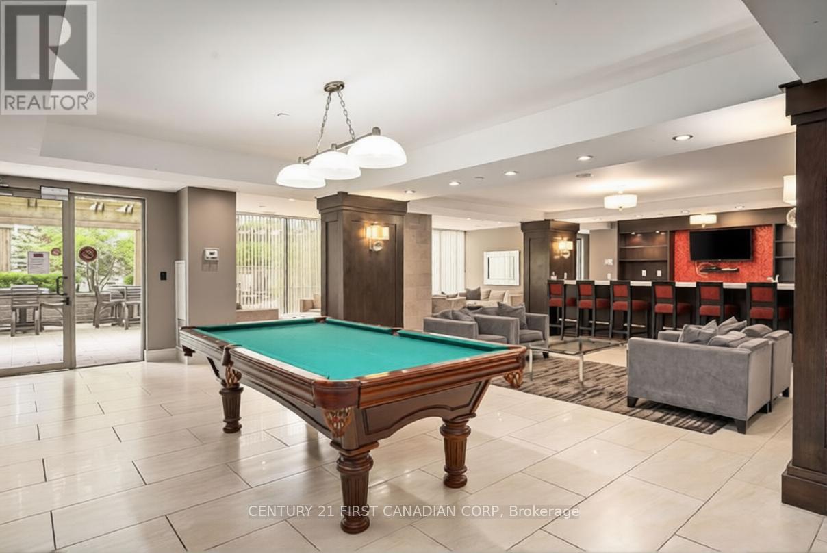 A pool table in a room with a realtor logo.