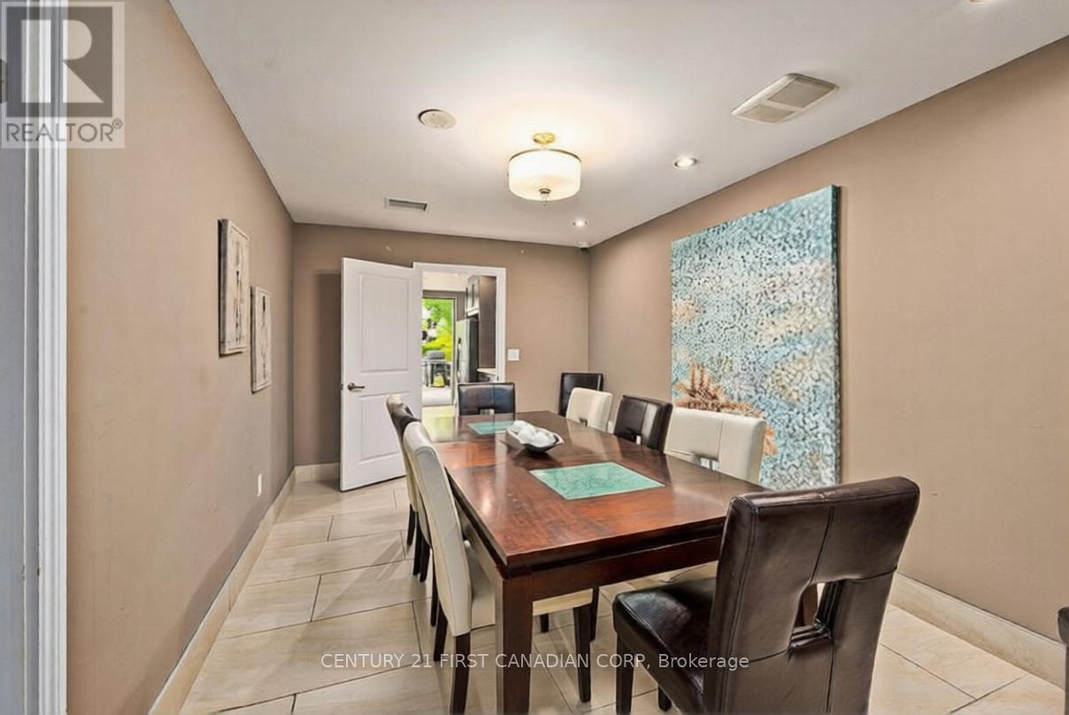 A dining room with a wooden table and chairs.