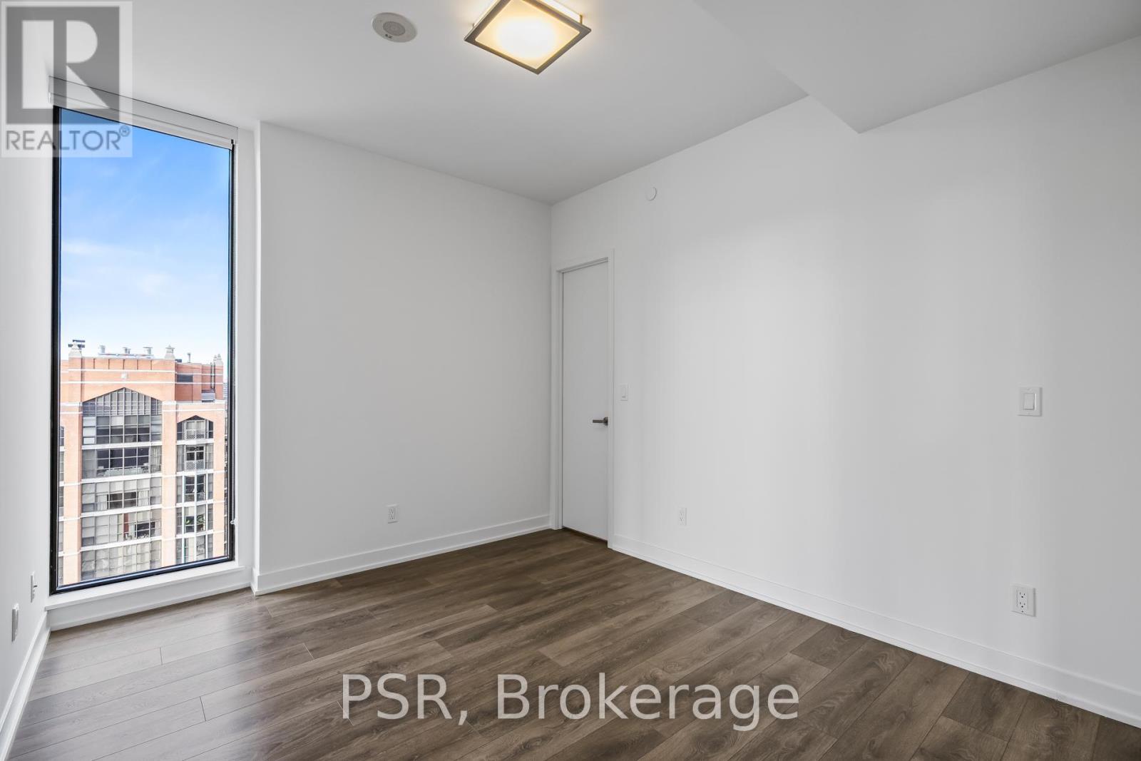 A room with a window overlooking a building with the words PSR Brokerage written on the bottom.