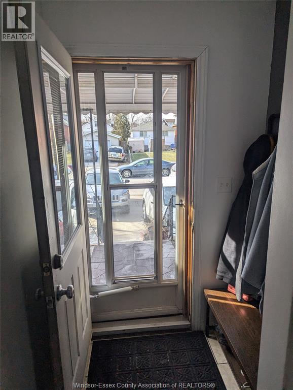 A doorway with a view of a parking lot outside.