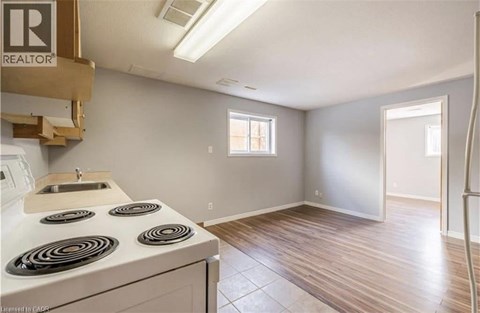 A kitchen with a stove top oven and a sink.