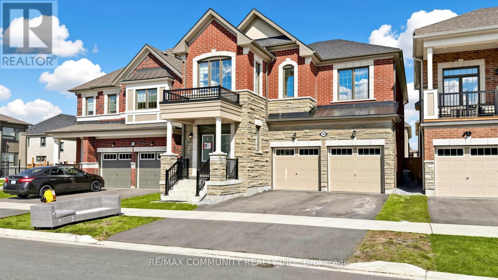 A large, multi-level house with a car parked in front.