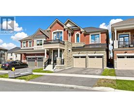 A large, multi-level house with a car parked in front.