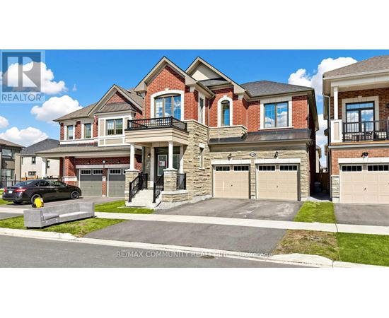 A large, multi-level house with a car parked in front.