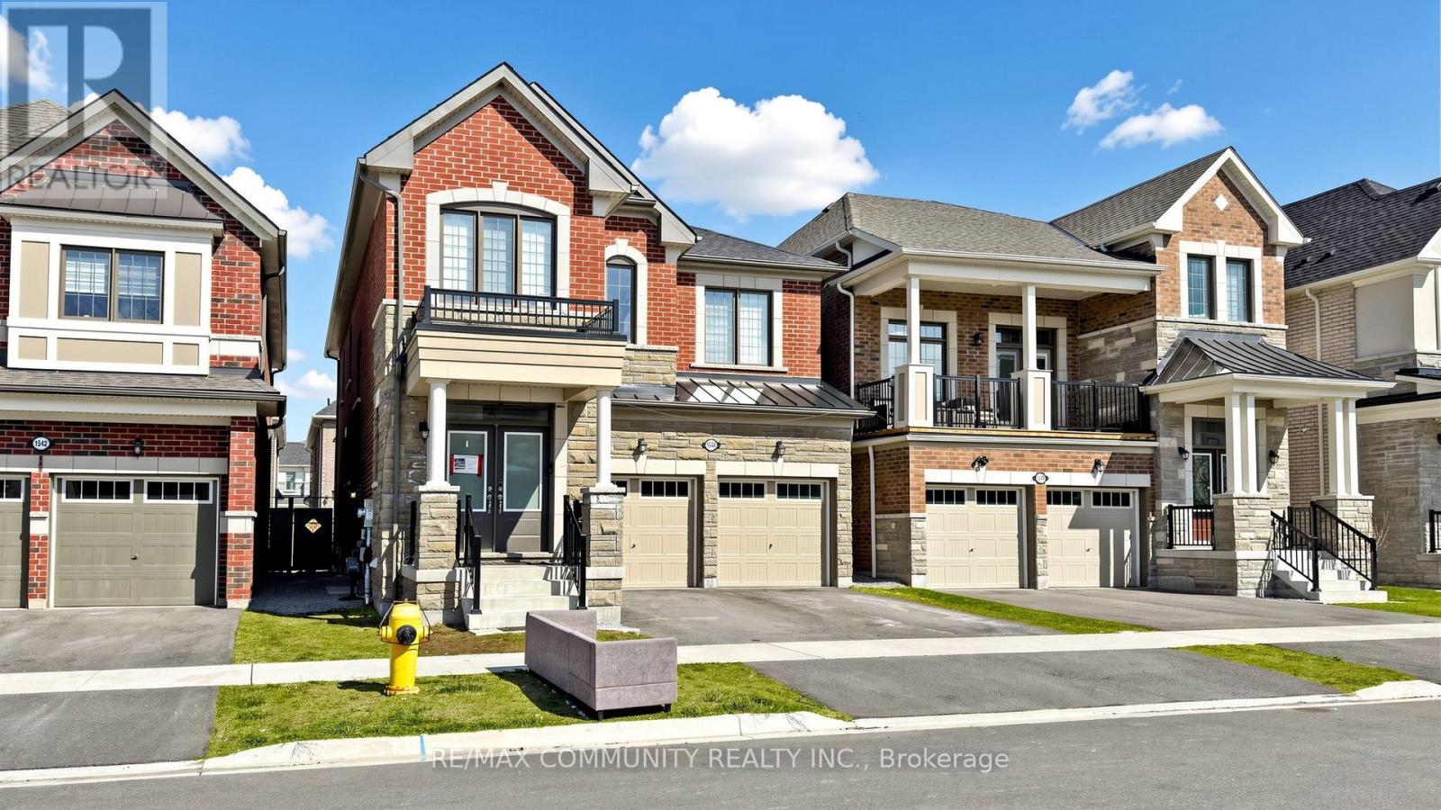 A row of houses with the text RE/MAX Community Realty, Brokerage on the bottom.