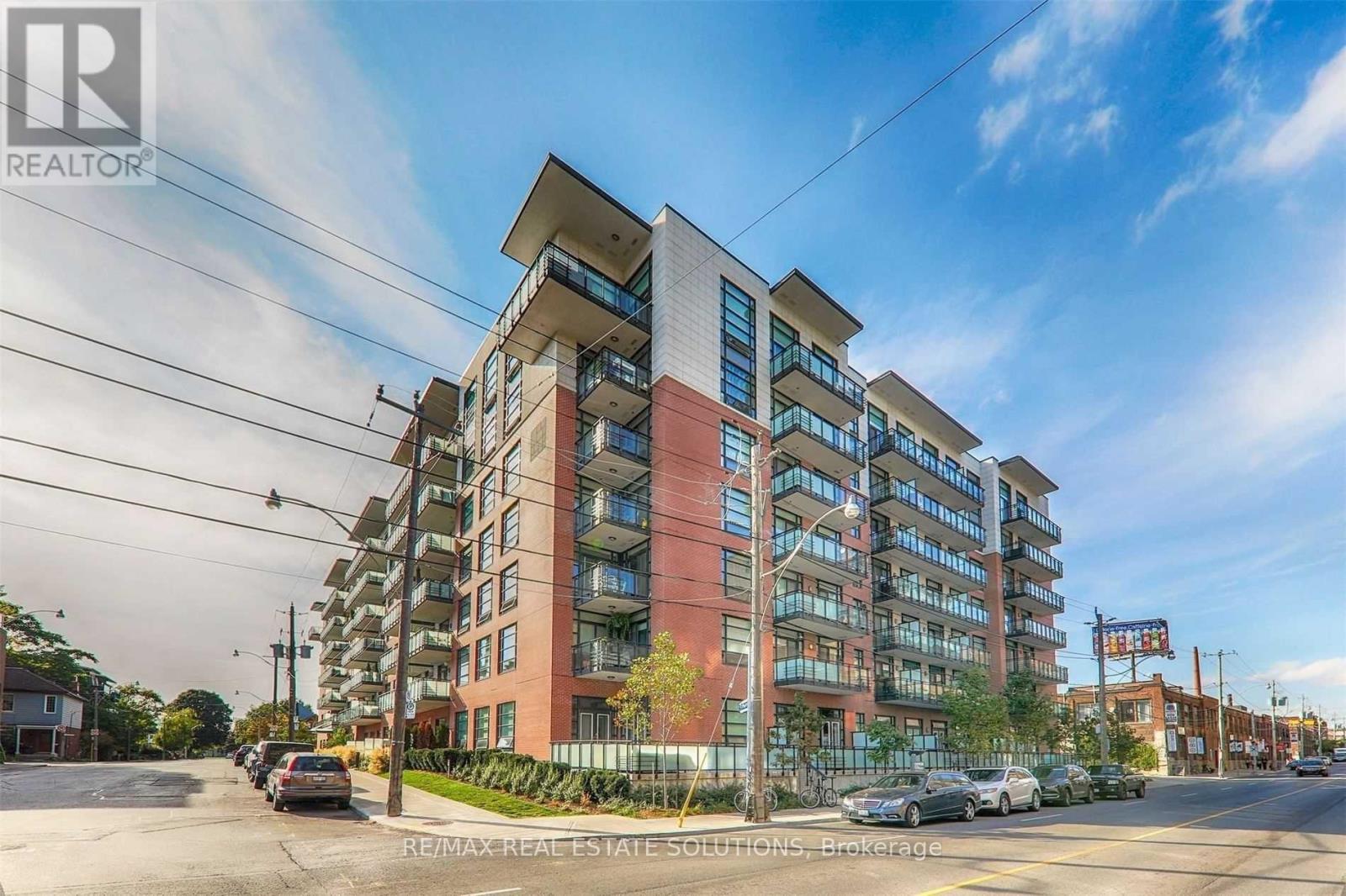A modern apartment building with a clear blue sky above.