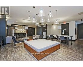 A bedroom with a bed in the center and a dining area in the background.