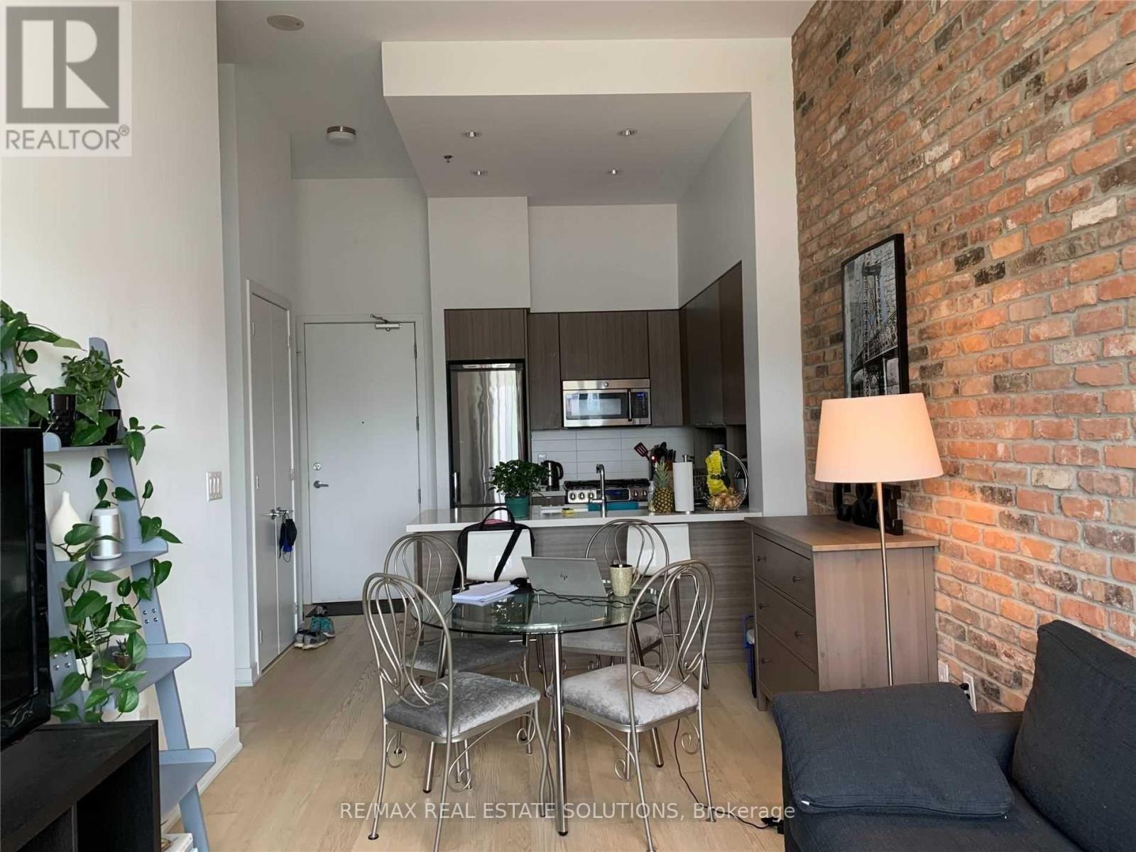 A modern kitchen with a dining table set up.