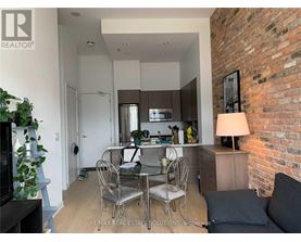 A modern kitchen with a dining table set up.