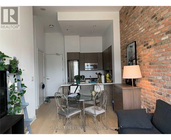 A modern kitchen with a dining table set up.