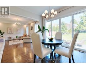 A well-lit dining room with a table set for two.