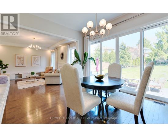 A well-lit dining room with a table set for two.