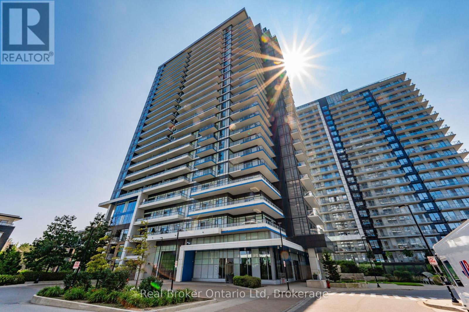 A tall building with a Real Broker Ontario Ltd. sign in front.