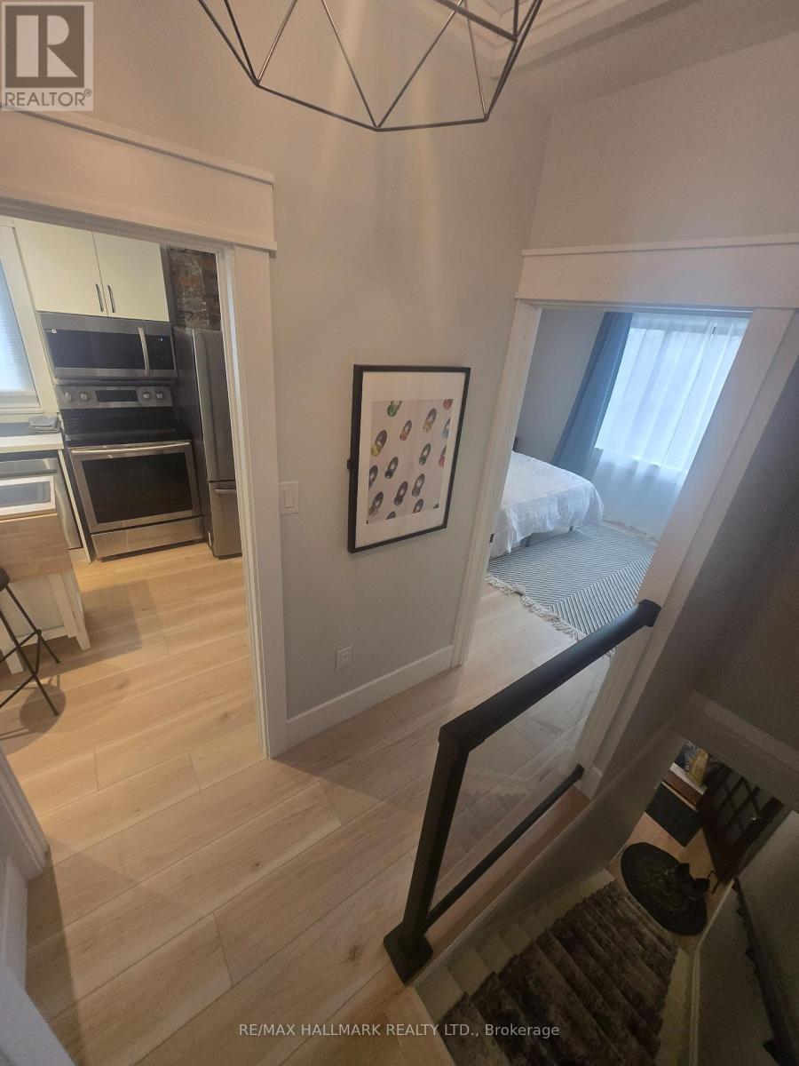 A bedroom with a bed and a picture on the wall.
