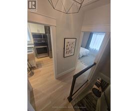 A bedroom with a bed and a picture on the wall.