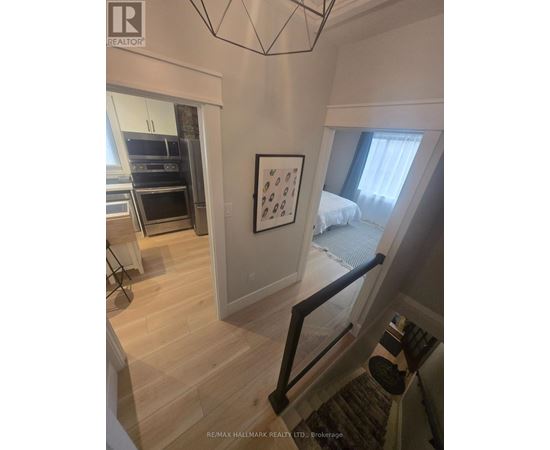 A bedroom with a bed and a picture on the wall.