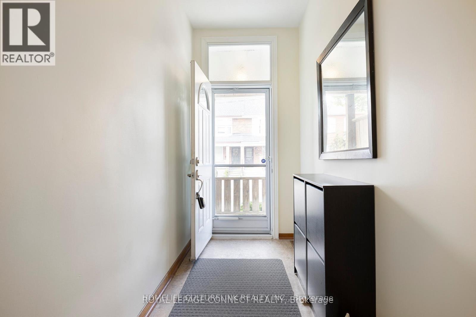 A hallway with a door leading to a balcony.