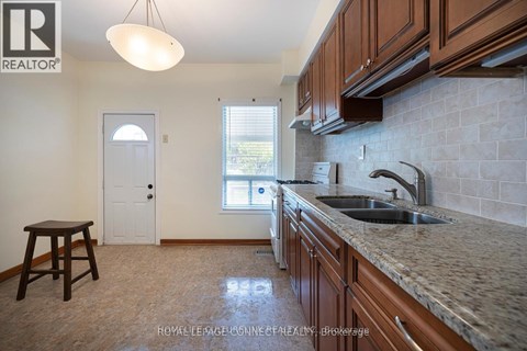 A kitchen with brown cabinets and a sink.