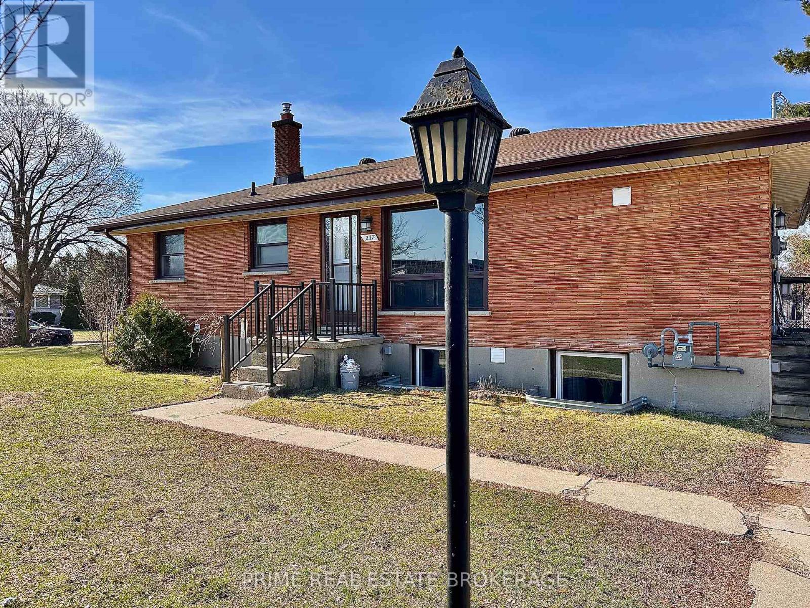 A brick house with a black lamp post in front.