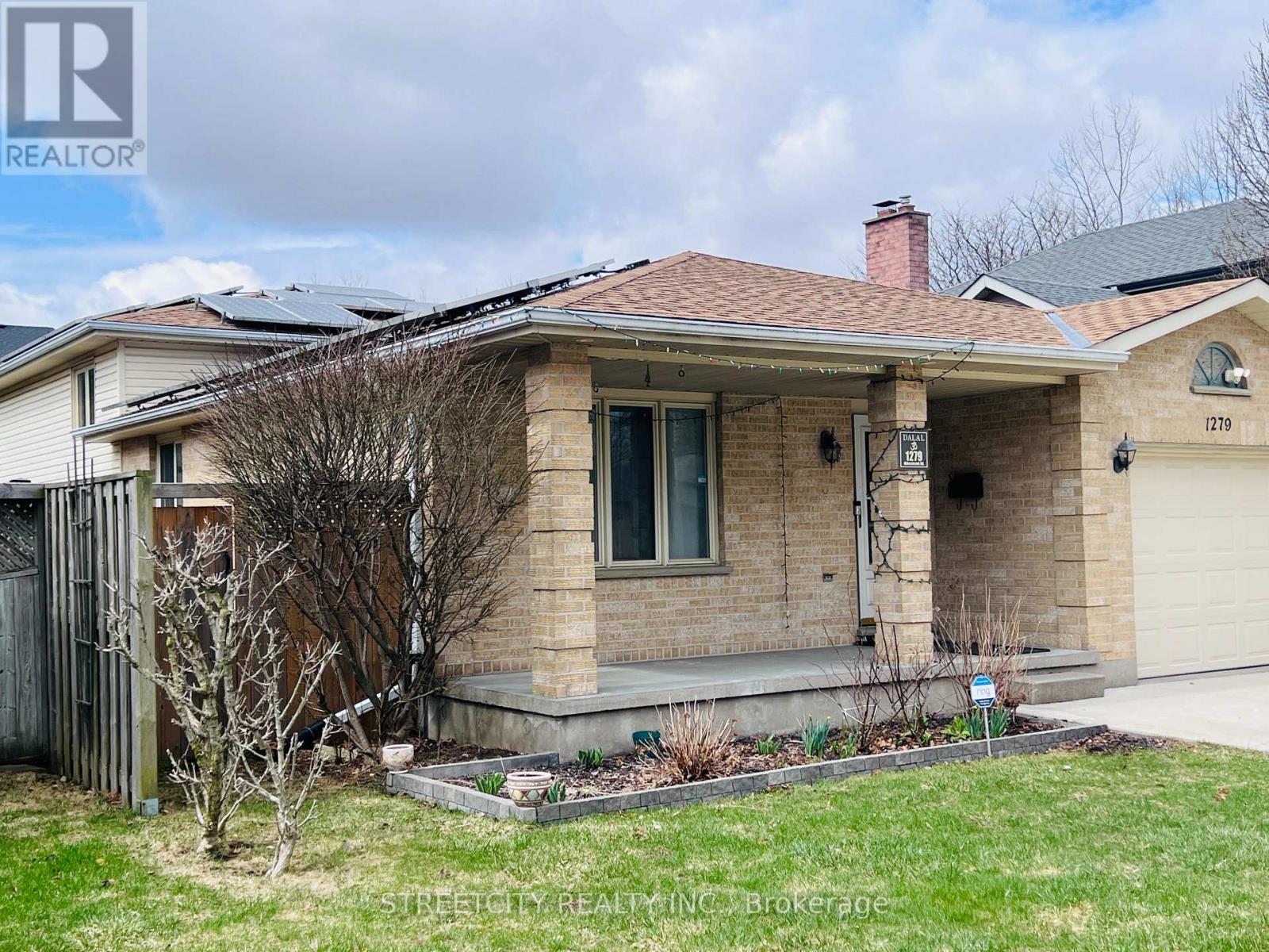 A house with a brown roof and a sign that says "1279" on it.