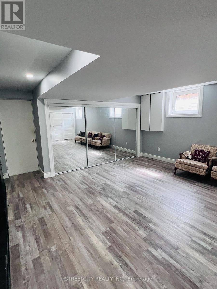 A living room with a couch and a slanted ceiling.