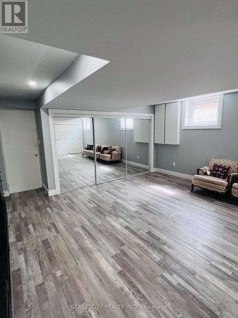 A living room with a couch and a slanted ceiling.
