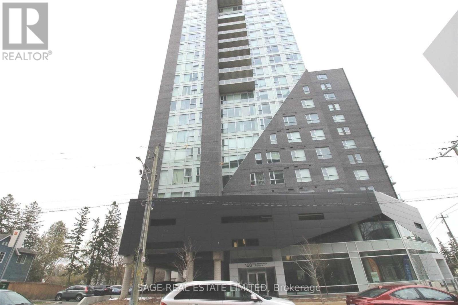 A tall building with a glass facade and a sign that reads "SAGE REAL ESTATE LIMITED" in front of it.