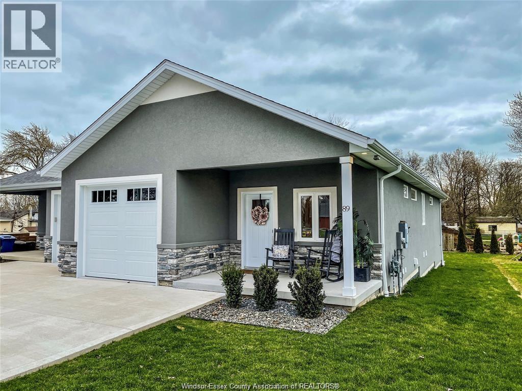 A house with a grey roof and a white garage door.