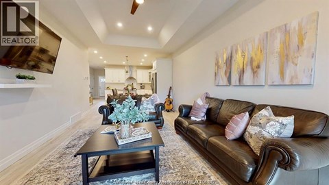 A living room with a brown leather couch and a coffee table.