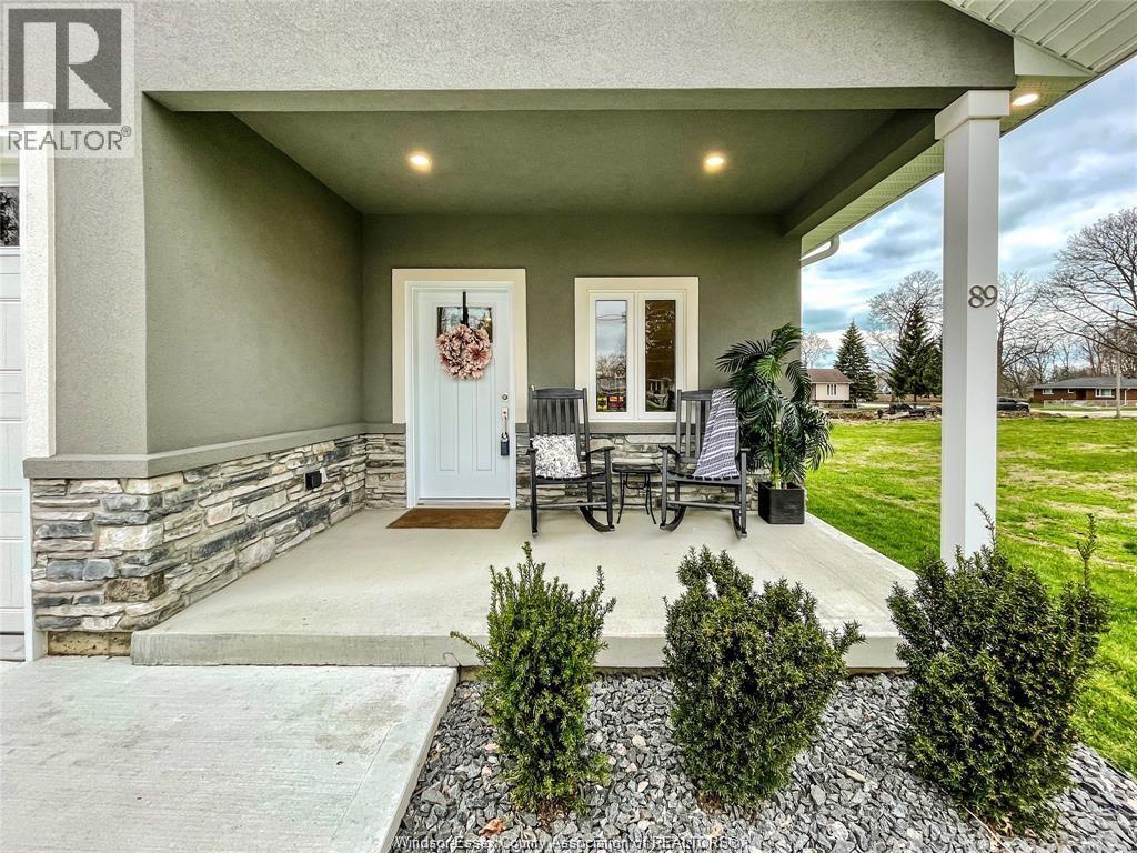 A house with a stone wall and a white door is for sale.