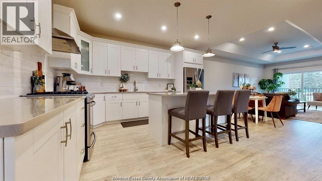 A well-lit kitchen with a dining table and chairs.