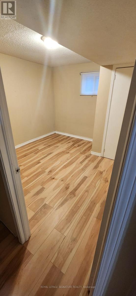 A room with wooden flooring and a window.