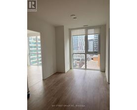 A room with a view of the city through large windows.
