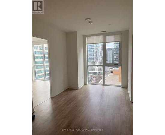A room with a view of the city through large windows.