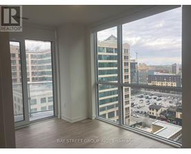 A room with a view of the cityscape through large windows.