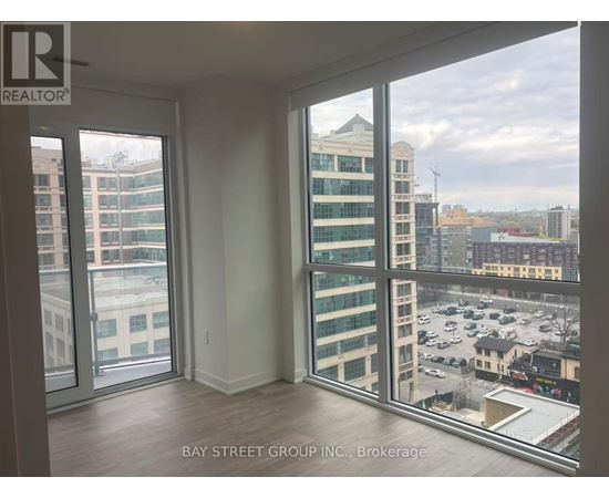 A room with a view of the cityscape through large windows.