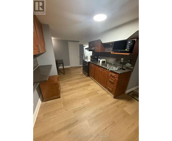 A kitchen with wooden cabinets and a countertop.