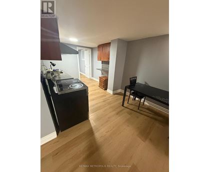 A kitchen with a stove top oven and a black counter top.
