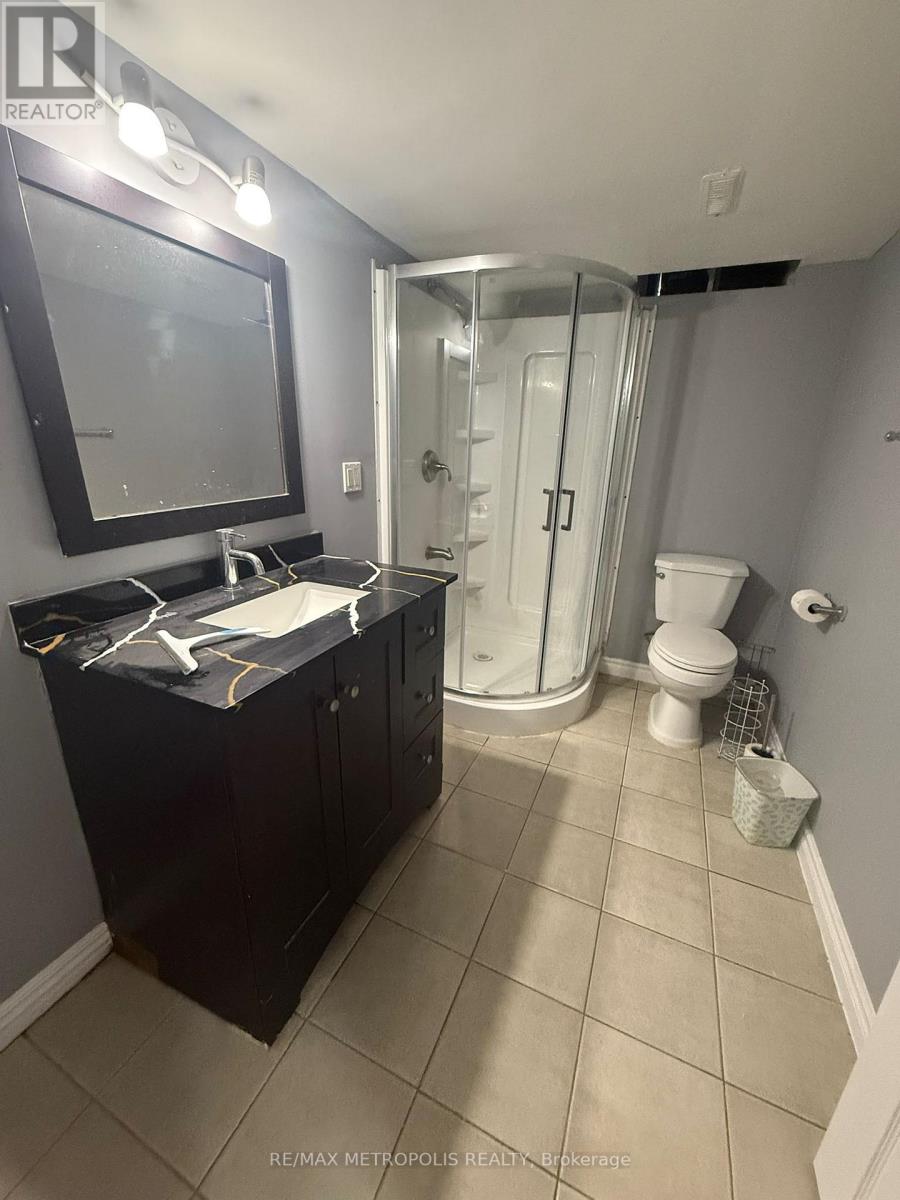 A bathroom with a black cabinet and a white sink.