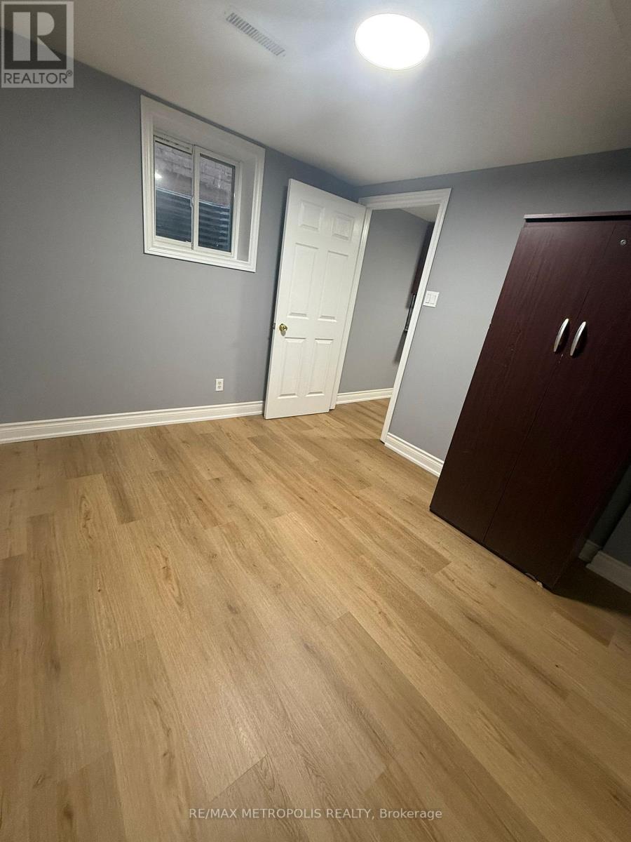 A room with wooden flooring and a white door.