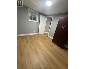 A room with wooden flooring and a white door.