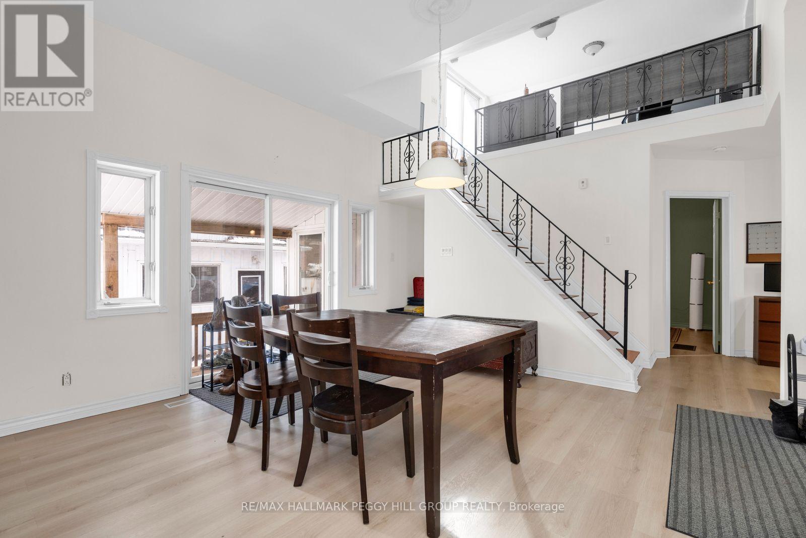 A dining room with a wooden table and chairs.
